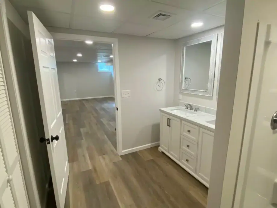 Finished basement with a new bathroom vanity and luxury vinyl plank flooring